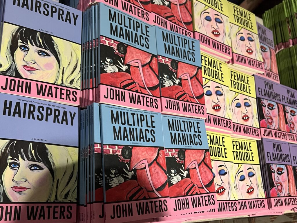 Colorful covers of John Waters books.